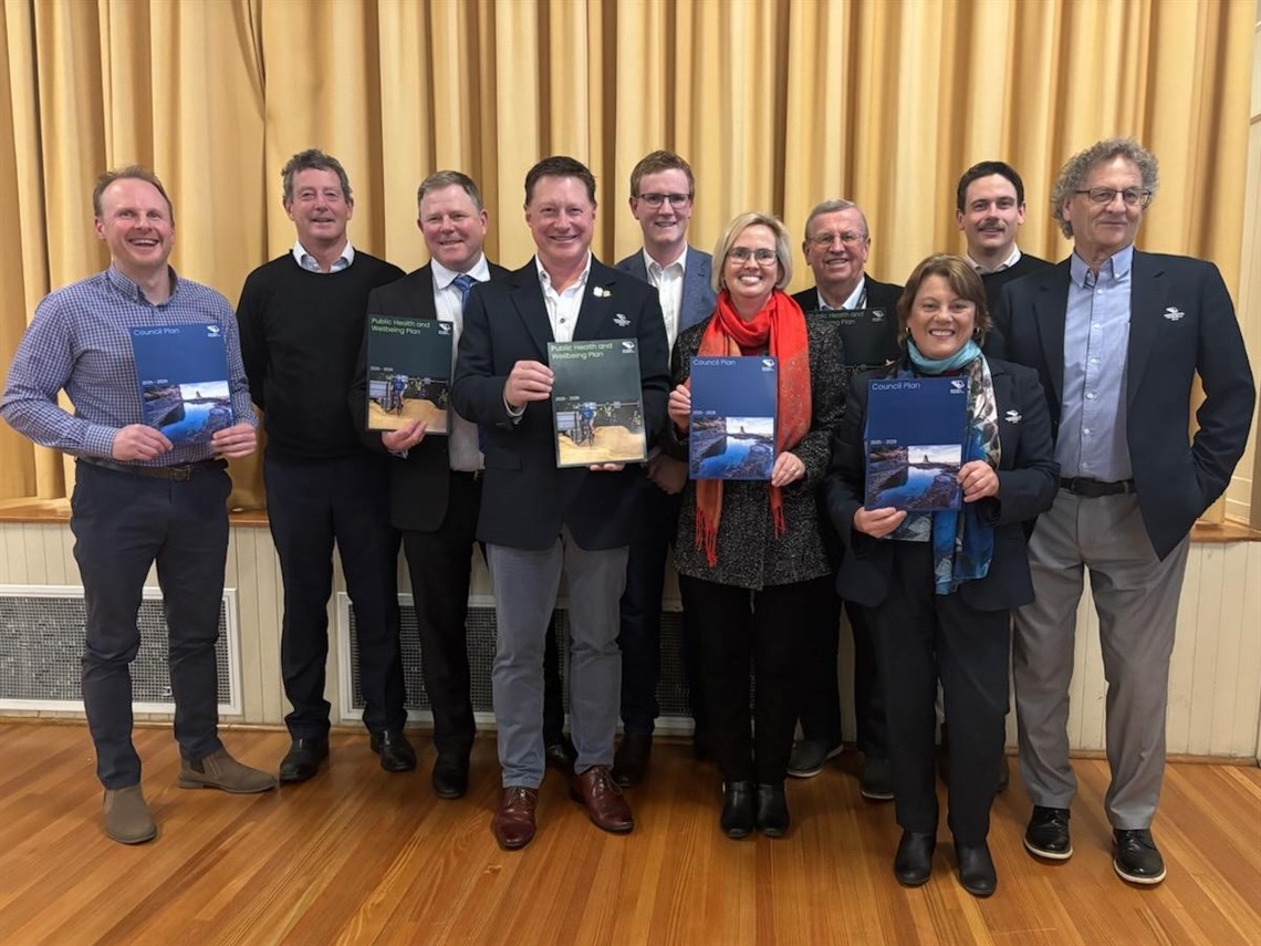 Councillors holding Councill Plan and Public Health and Wellbeing Plan documents.jpg