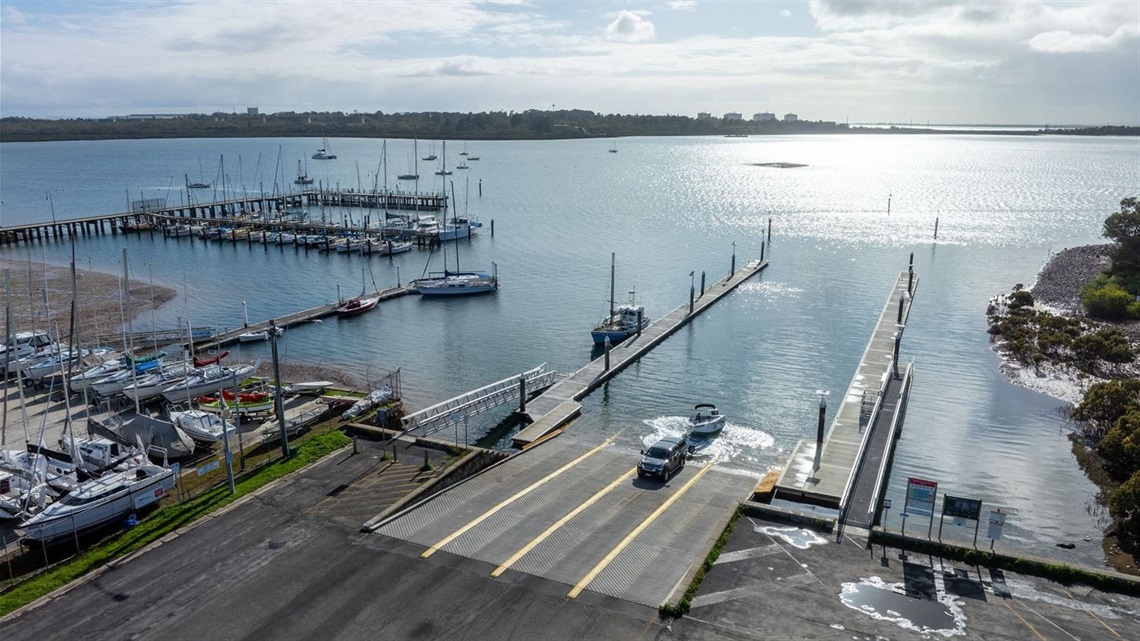 image of Hastings boat ramp, including a view of the water and boats docked 
