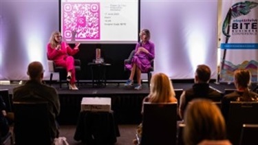 Shannon Smit and guest on stage as a panellist discussion