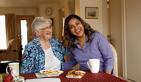 A Uniting AgeWell Home Care Worker is photographed with a customer.