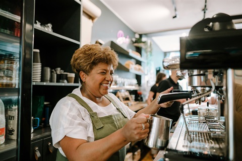Barista heating up the milk