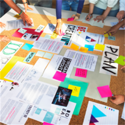 Staff around a table making a story for their brand