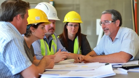 Builders & Trades sitting around drawings