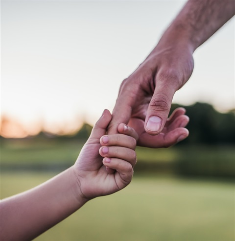 Man holding childs hand.jpg
